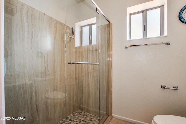 bathroom with toilet and walk in shower