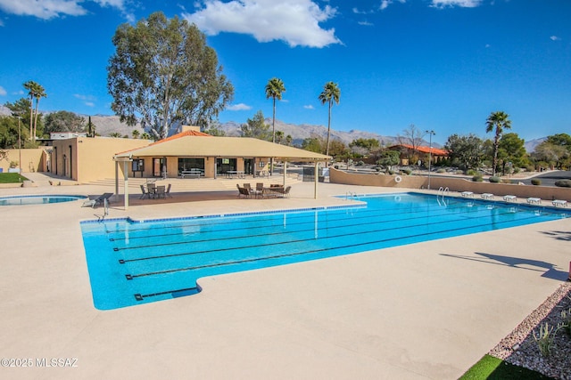 view of pool featuring a mountain view and a patio