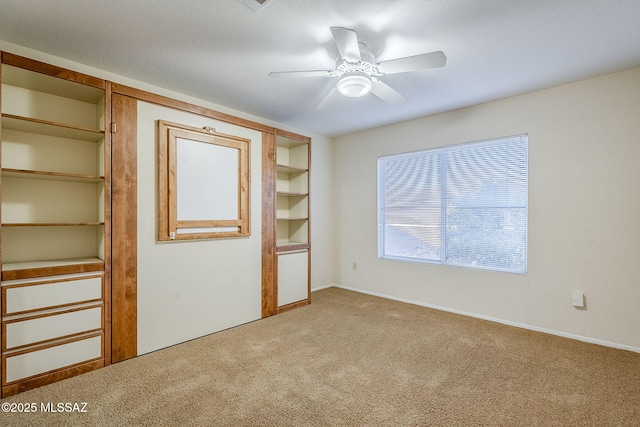 unfurnished bedroom with ceiling fan and carpet flooring