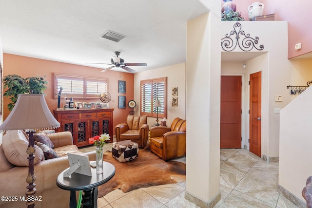 living room with ceiling fan and light tile patterned floors