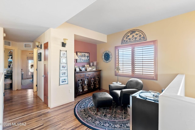 sitting room with hardwood / wood-style floors