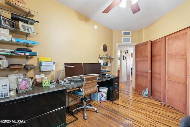 office space featuring light wood-type flooring and ceiling fan