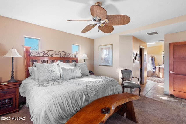 bedroom with multiple windows, light carpet, a closet, and ceiling fan