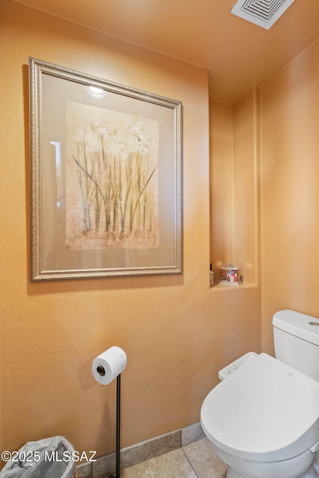 bathroom featuring tile patterned floors and toilet