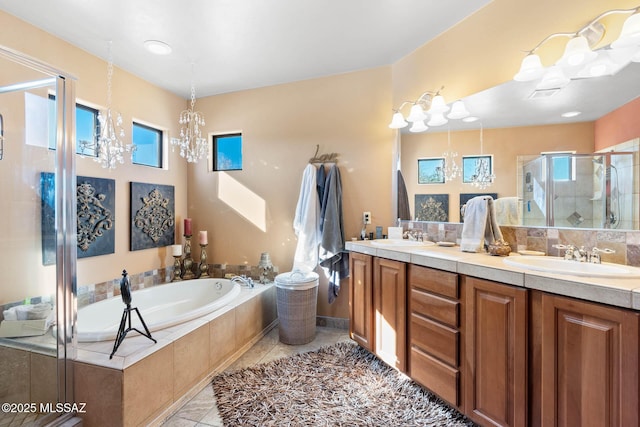 bathroom featuring tile patterned floors, vanity, independent shower and bath, and a notable chandelier