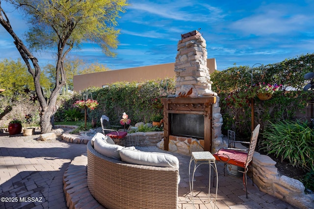 view of patio / terrace featuring an outdoor stone fireplace