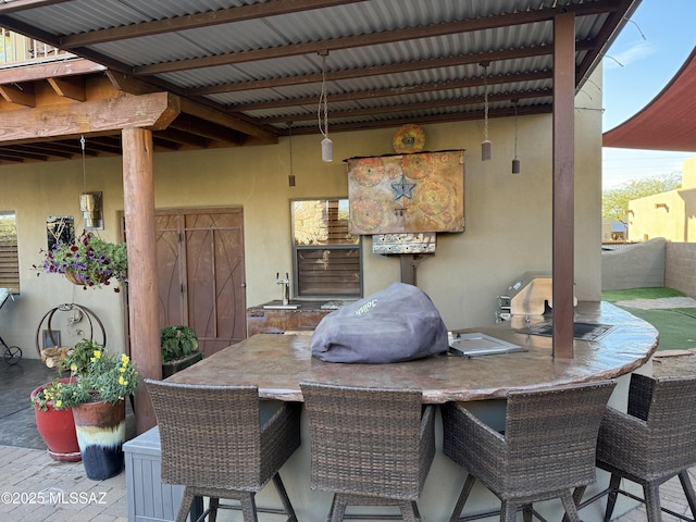 view of patio / terrace featuring an outdoor kitchen and an outdoor bar