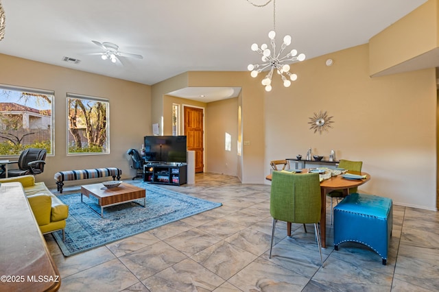 living room featuring ceiling fan with notable chandelier