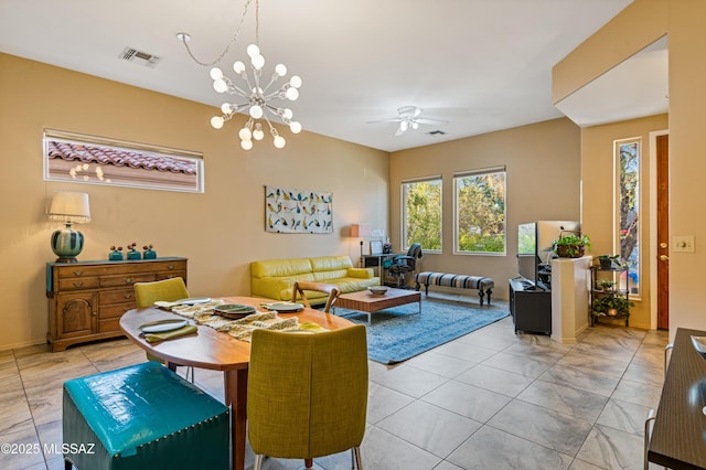 dining room with ceiling fan with notable chandelier