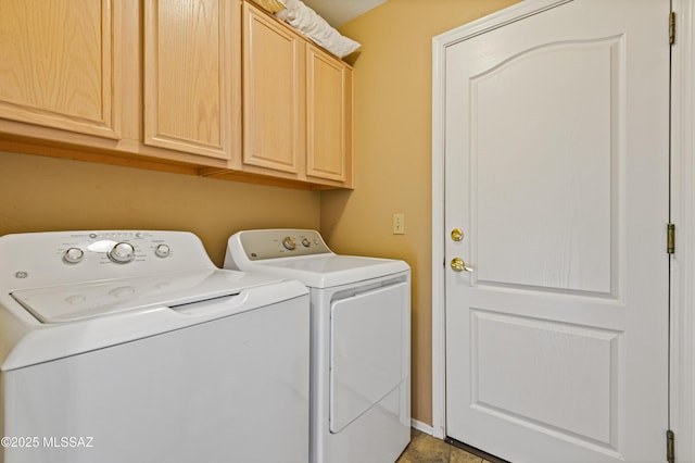 washroom featuring cabinets and washing machine and dryer