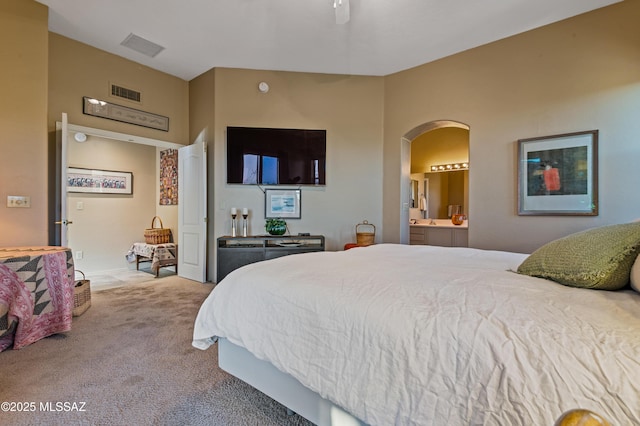 carpeted bedroom featuring ensuite bathroom