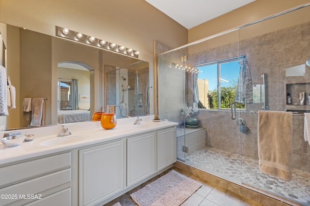 bathroom featuring walk in shower, vanity, and tile patterned flooring