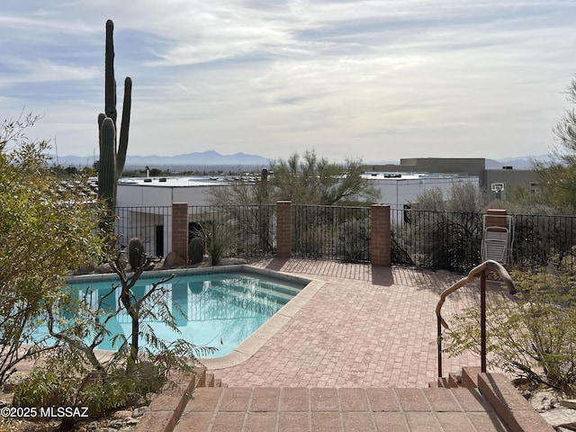 view of pool featuring a mountain view and a patio area