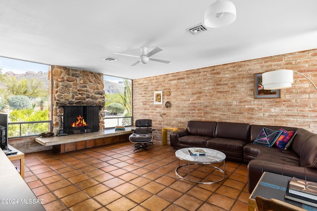 living room featuring a fireplace, tile patterned flooring, plenty of natural light, and ceiling fan