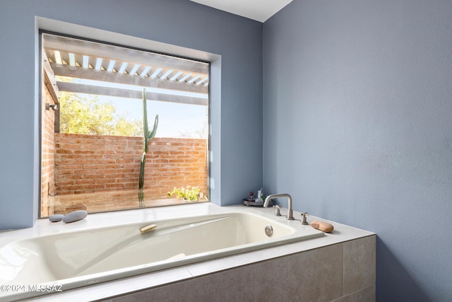 bathroom featuring a relaxing tiled tub