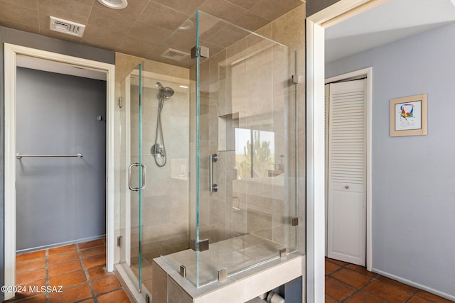 bathroom with tile patterned floors and a shower with shower door