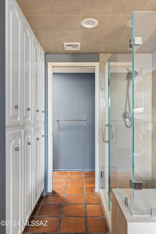 bathroom featuring a shower with door