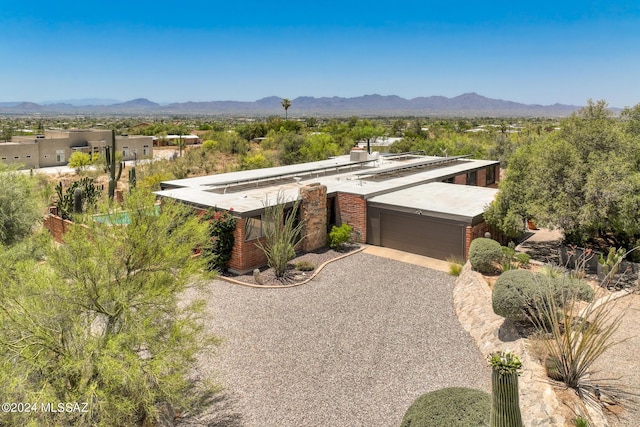 view of front of property with a mountain view and a garage