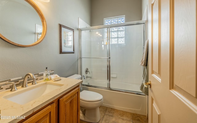 full bathroom with vanity, tile patterned floors, enclosed tub / shower combo, and toilet