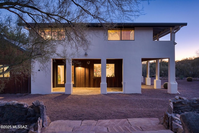 view of back house at dusk