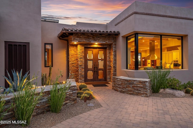 exterior entry at dusk with french doors