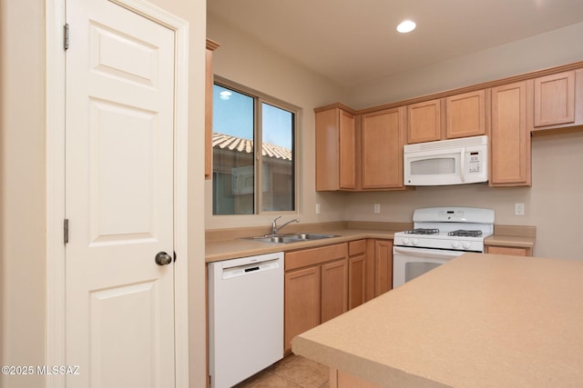 kitchen featuring sink, light tile patterned floors, and white appliances