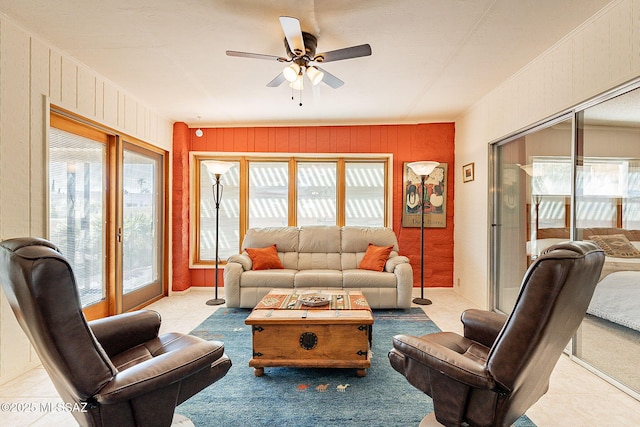 living room with ceiling fan and a healthy amount of sunlight