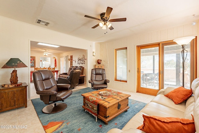 living room with light tile patterned floors and ceiling fan