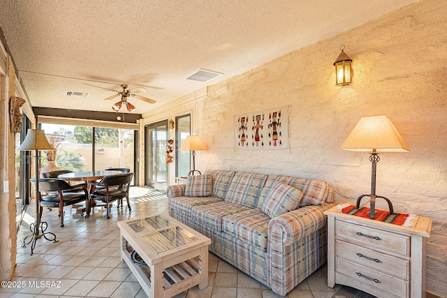 tiled living room featuring a textured ceiling and ceiling fan