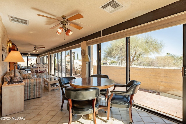 sunroom featuring ceiling fan