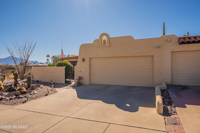 pueblo-style house featuring a garage