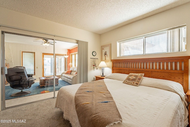 bedroom featuring ceiling fan, a textured ceiling, and carpet flooring