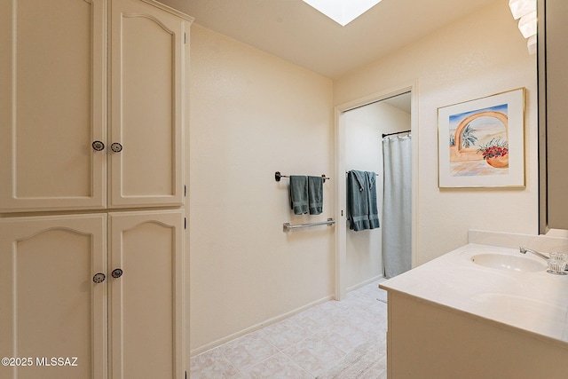 bathroom featuring vanity and a skylight