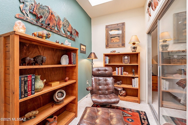 sitting room featuring a skylight