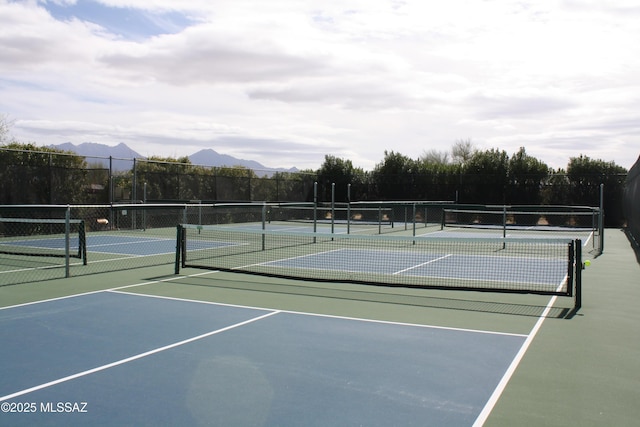 view of tennis court with a mountain view