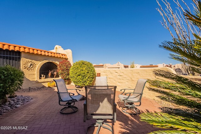 view of patio / terrace with exterior fireplace