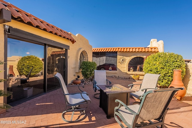 view of patio / terrace featuring an outdoor fire pit