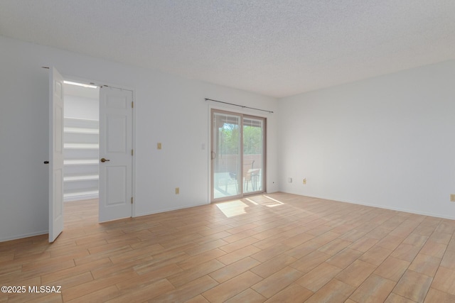 spare room with a textured ceiling