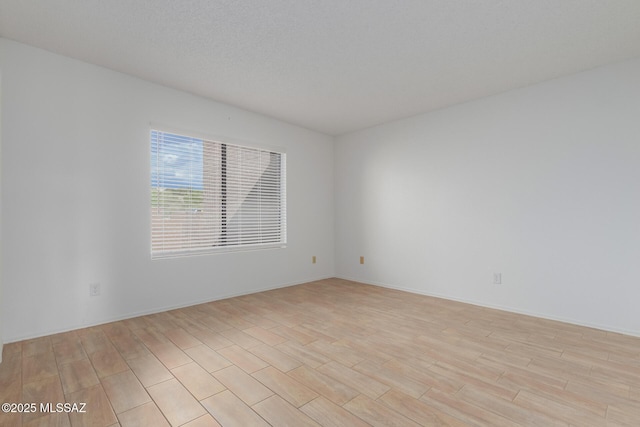 unfurnished room with light hardwood / wood-style flooring