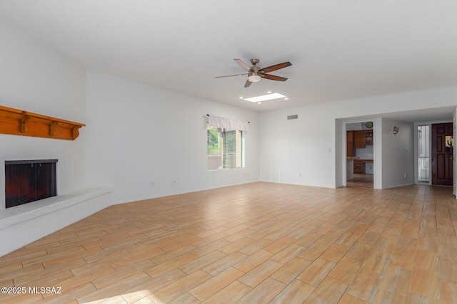 unfurnished living room featuring ceiling fan