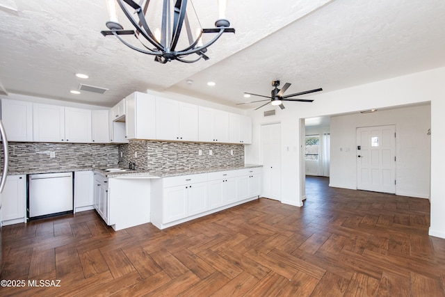 kitchen with white cabinetry, dark parquet flooring, and ceiling fan with notable chandelier