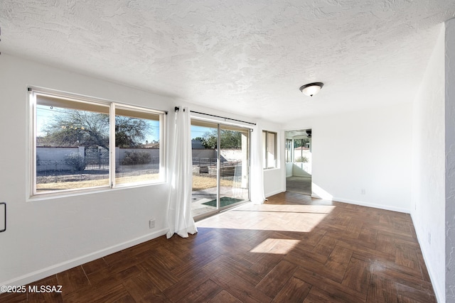 unfurnished room featuring parquet flooring