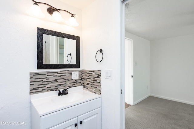 bathroom featuring tasteful backsplash and vanity