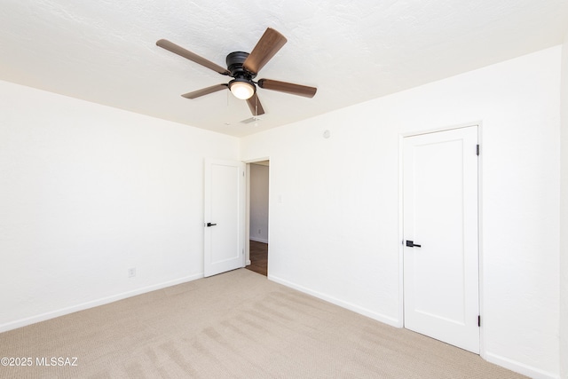 empty room with light carpet and ceiling fan