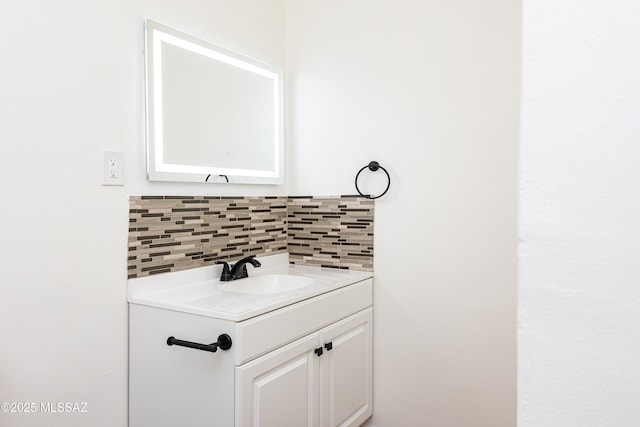 bathroom with tasteful backsplash and vanity