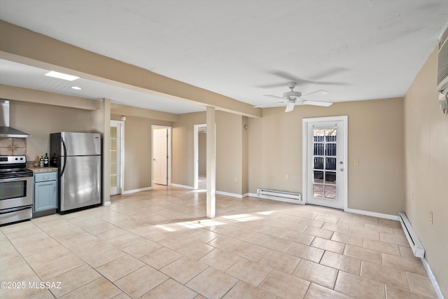 kitchen featuring ceiling fan, a baseboard heating unit, stainless steel appliances, and wall chimney exhaust hood