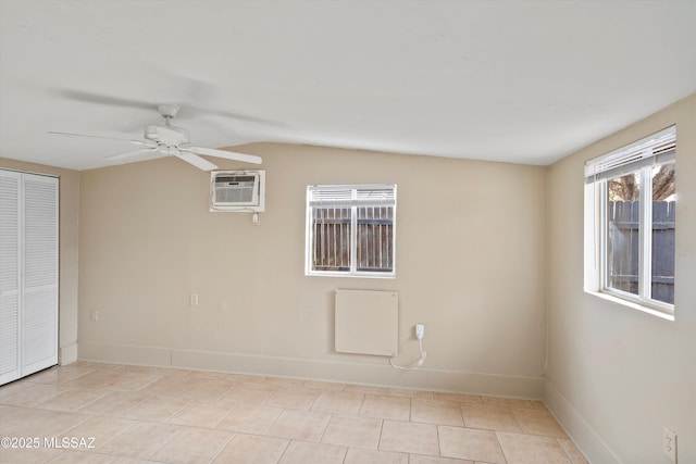 tiled spare room featuring a wall mounted air conditioner and ceiling fan