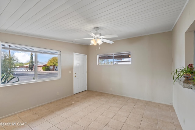 tiled spare room featuring wood ceiling and ceiling fan