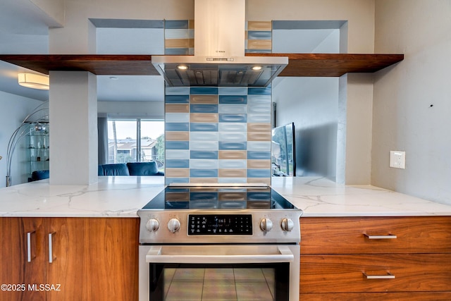 kitchen with stainless steel electric range, light stone countertops, and island exhaust hood