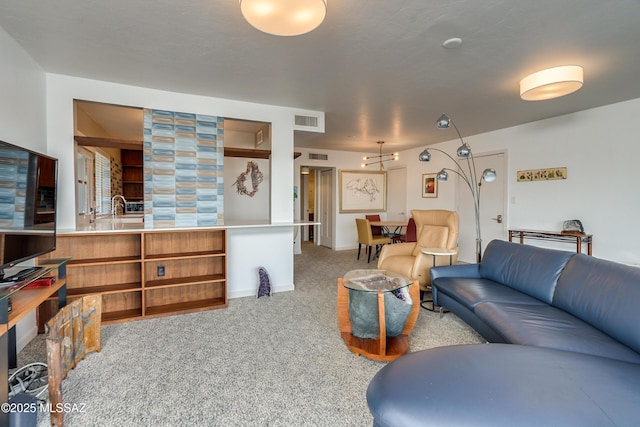 carpeted living room with sink